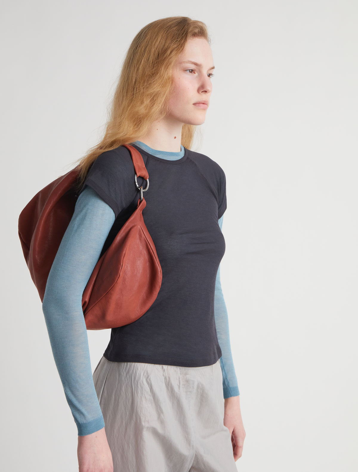 Dry elongated wrap around hobo style shoulder bag terracotta