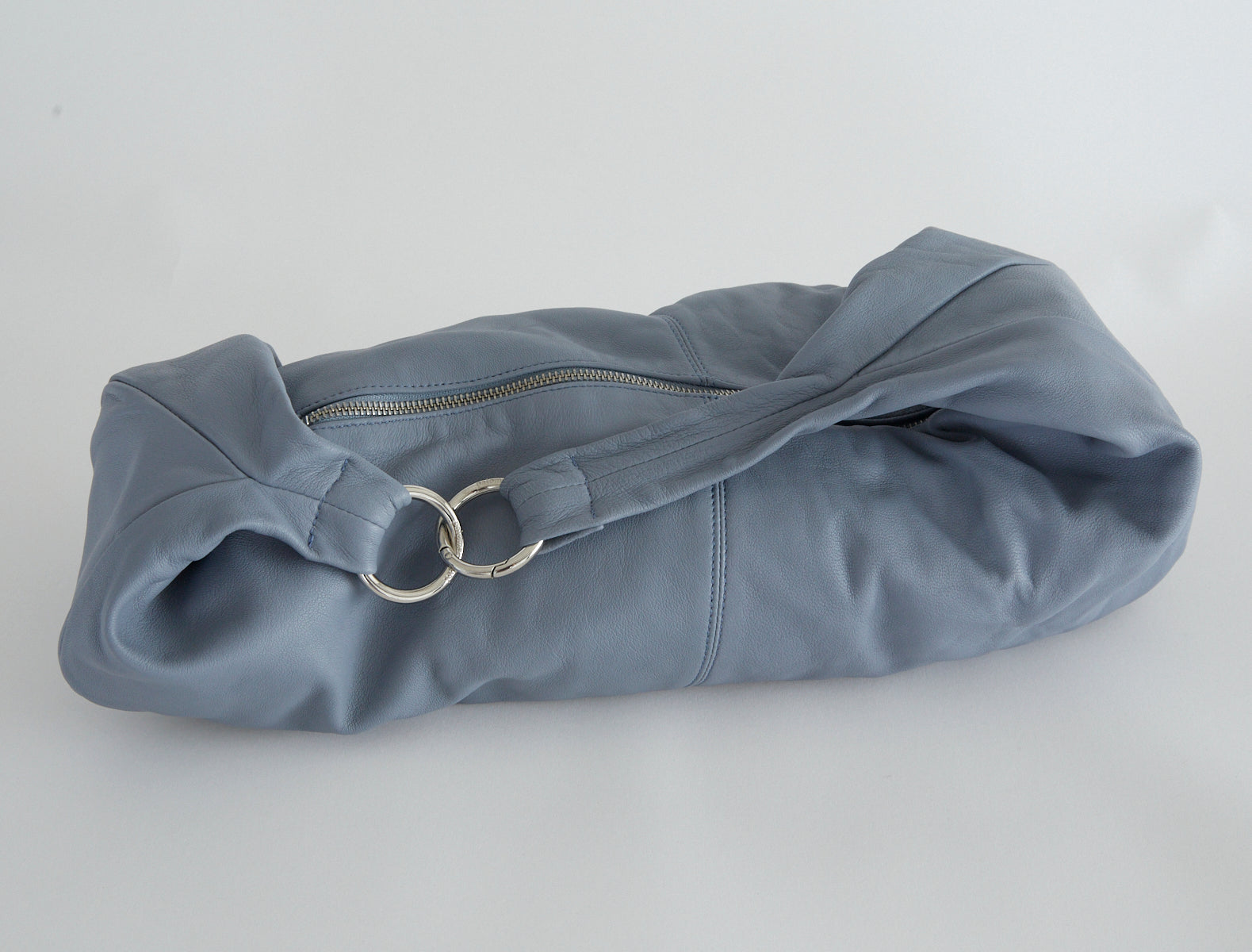 Dry elongated wrap around hobo style shoulder bag lightgreyishblue